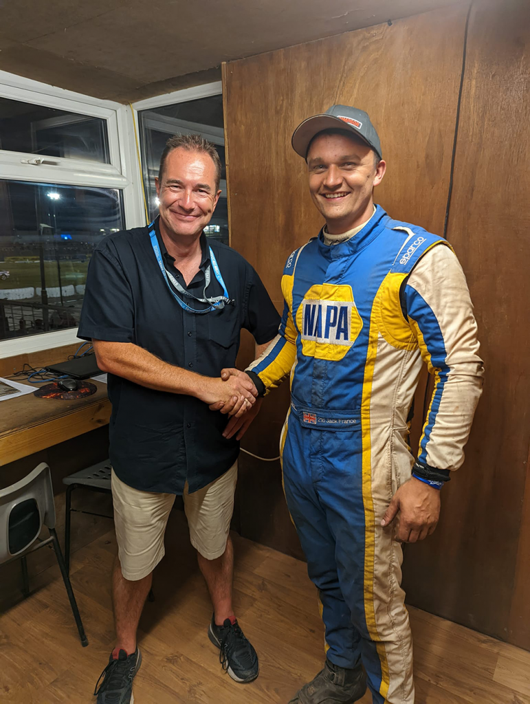 Jack France in his NAPA overalls shakes hands with David Addison in Skegness