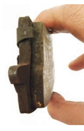 Hand holding brake pad