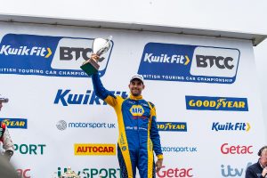 Cammish holds his trophy in the air at BTCC Brands Hatch