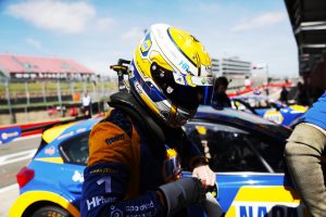 Sutton showing off his new NAPA helmet at Brands Hatch.