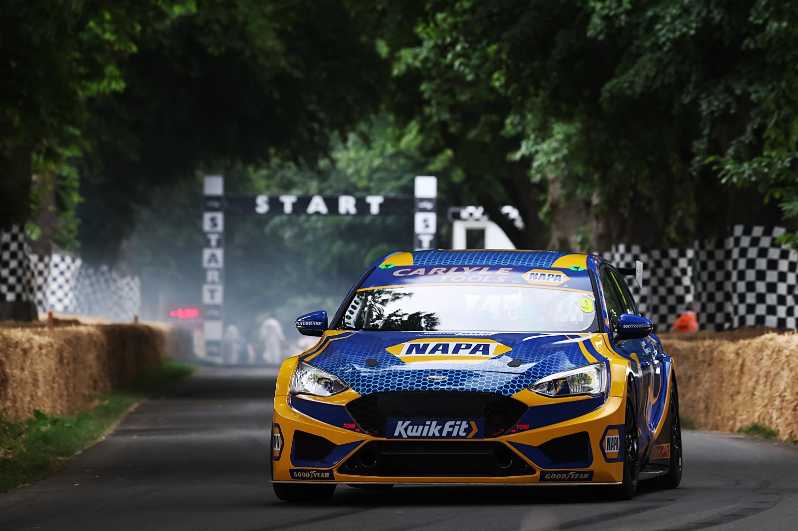 The NAPA Racing UK car in front of the start line at Goodwood Festival of Speed's famous Hillclimb.