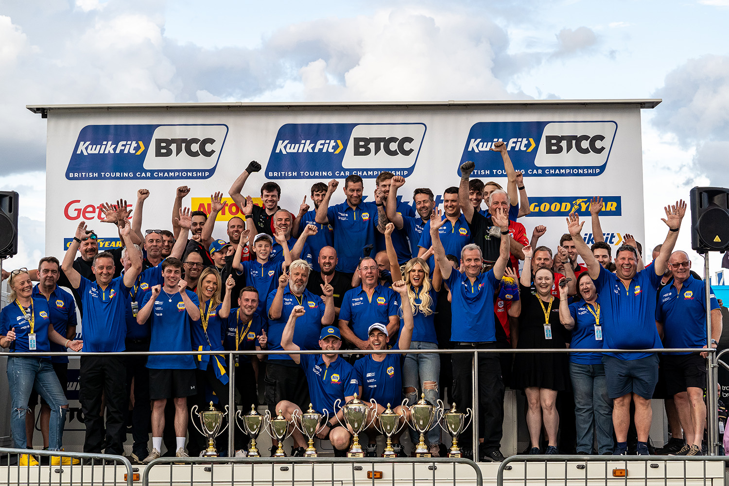 The entire NAPA Racing UK team stands at the podiums celebrating a brilliant weekend at BTCC Thruxton
