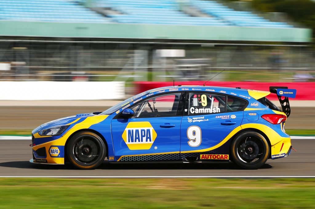 Dan Cammish whizzes past in his NAPA Racing UK Ford Focus at BTCC Silverstone, the background blurring behind him.