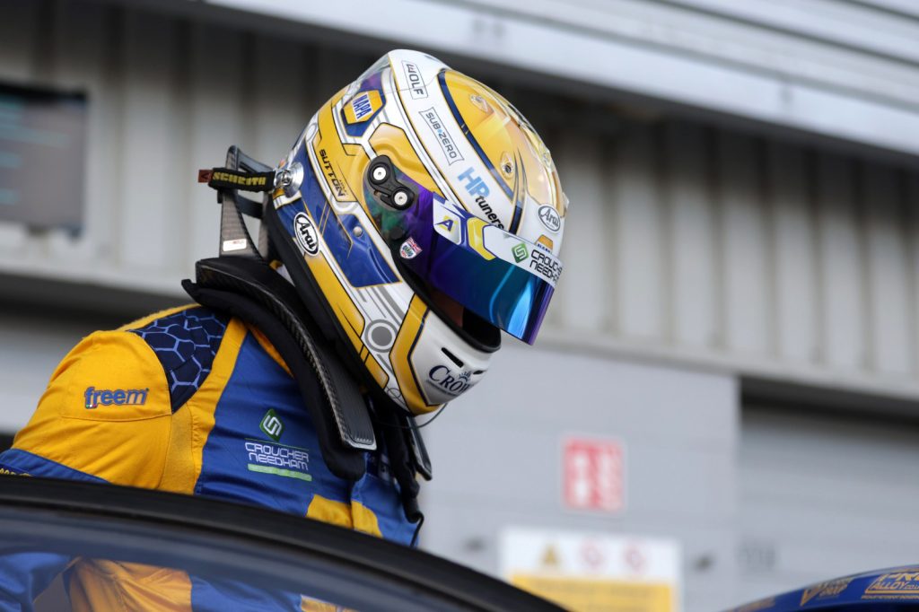 Ash Sutton bows his head in his NAPA helmet at BTCC Silverstone