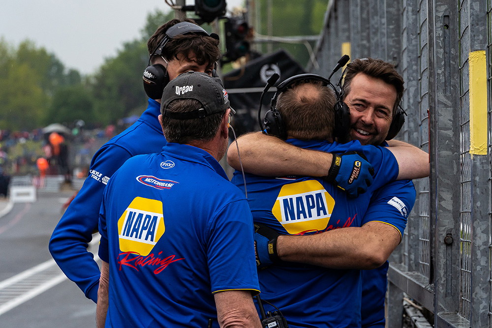 The NAPA Racing UK team embrace each other at BTCC Brands Hatch Indy.