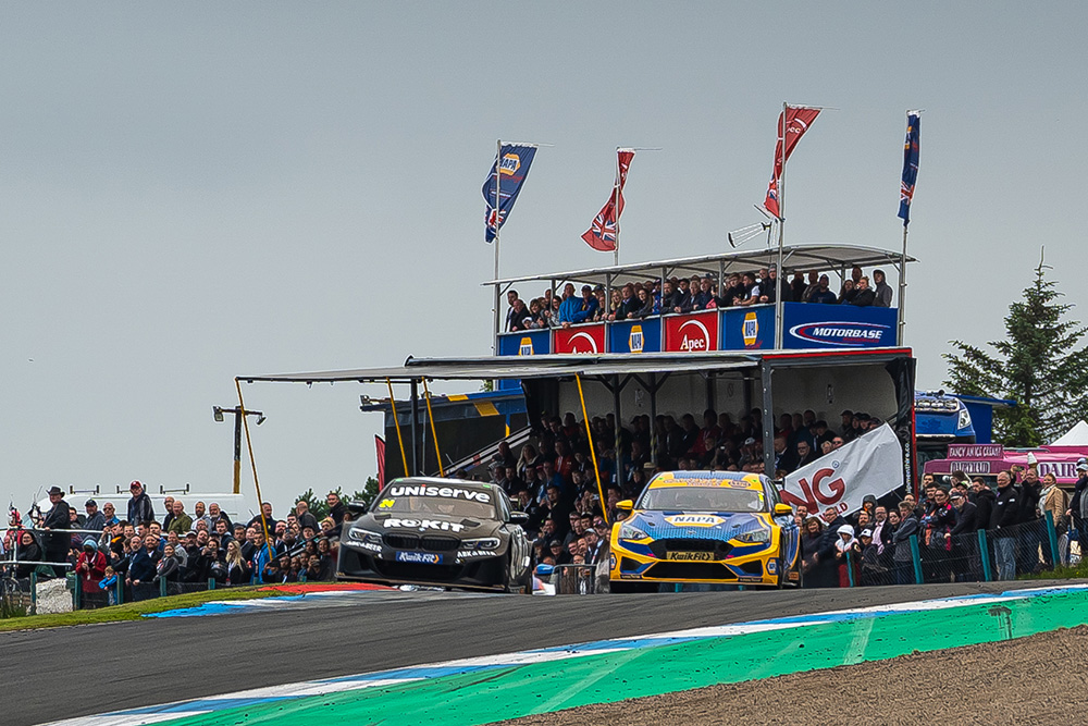 NAPA Racing UK car overtakes a competitor in front of the NAPA VIP crowd.